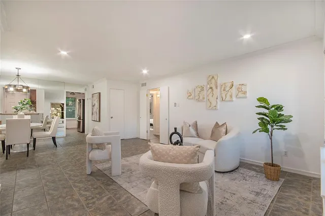 a living room with furniture and a potted plant