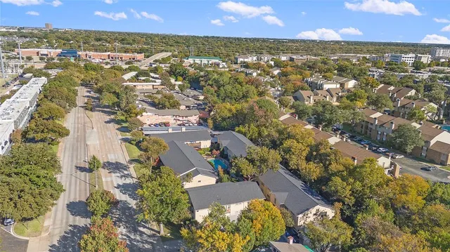 an aerial view of residential houses with outdoor space