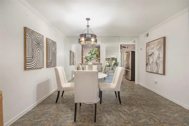 a dining room with furniture a chandelier and window