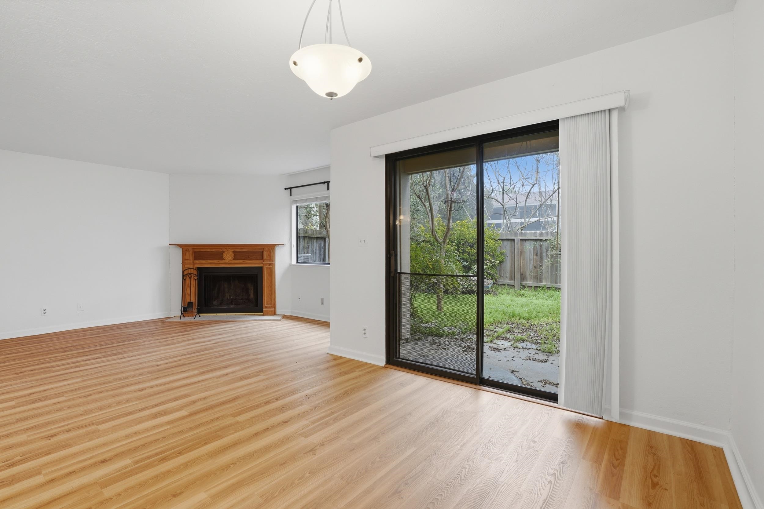 3401 Bermuda Avenue, Unit 6 Davis, CA 95616 - Photo 14 of 43 a view of an empty room with wooden floor and a window