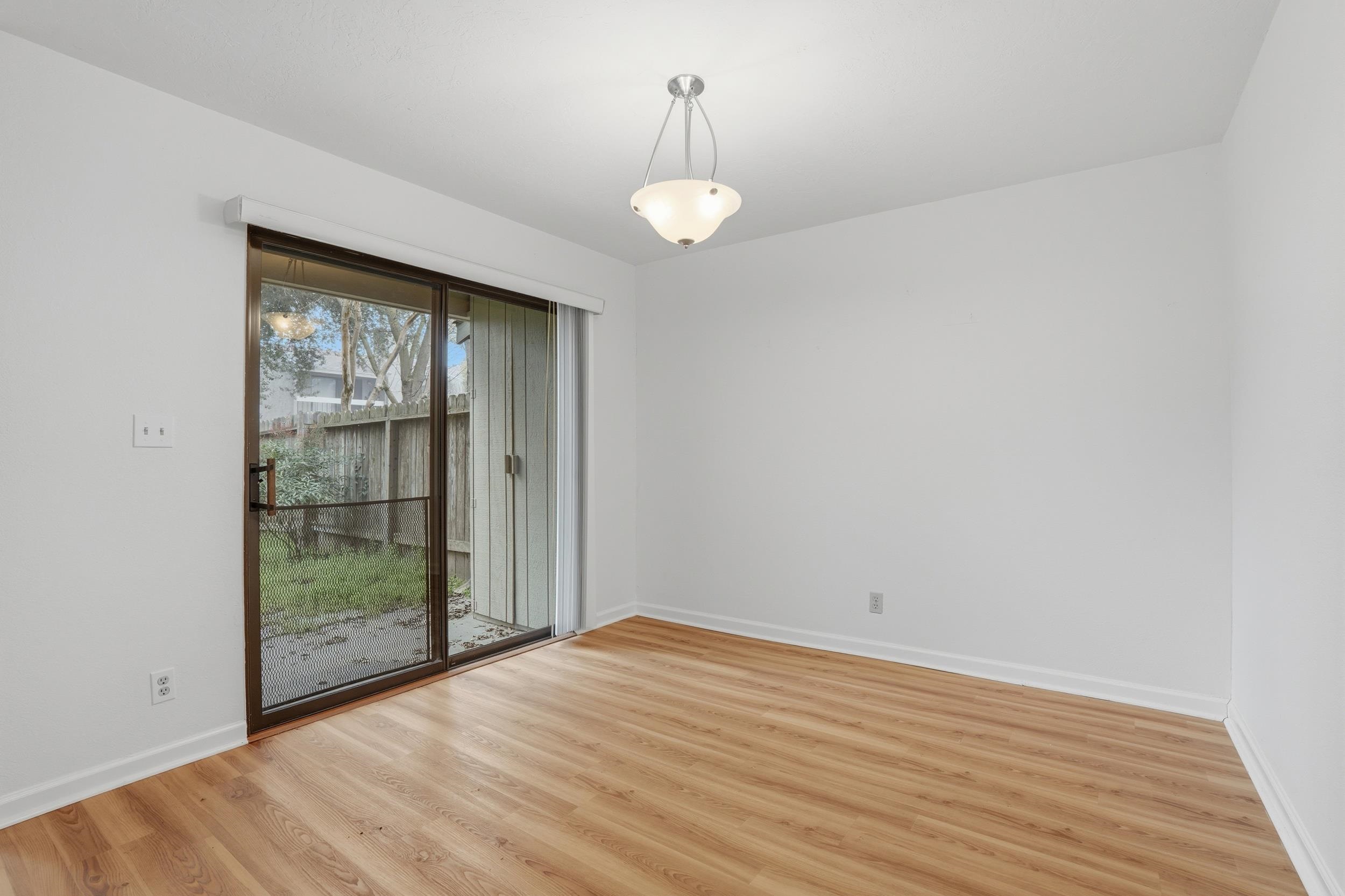 3401 Bermuda Avenue, Unit 6 Davis, CA 95616 - Photo 17 of 43 an empty room with wooden floor and windows