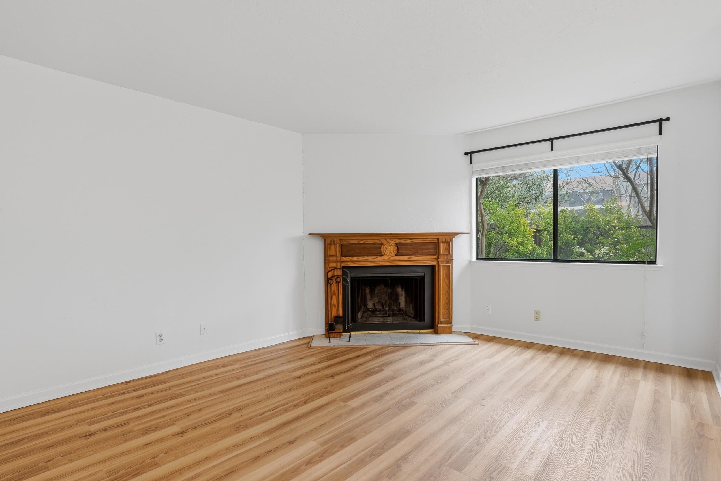 3401 Bermuda Avenue, Unit 6 Davis, CA 95616 - Photo 18 of 43 a view of empty room with wooden floor and fireplace