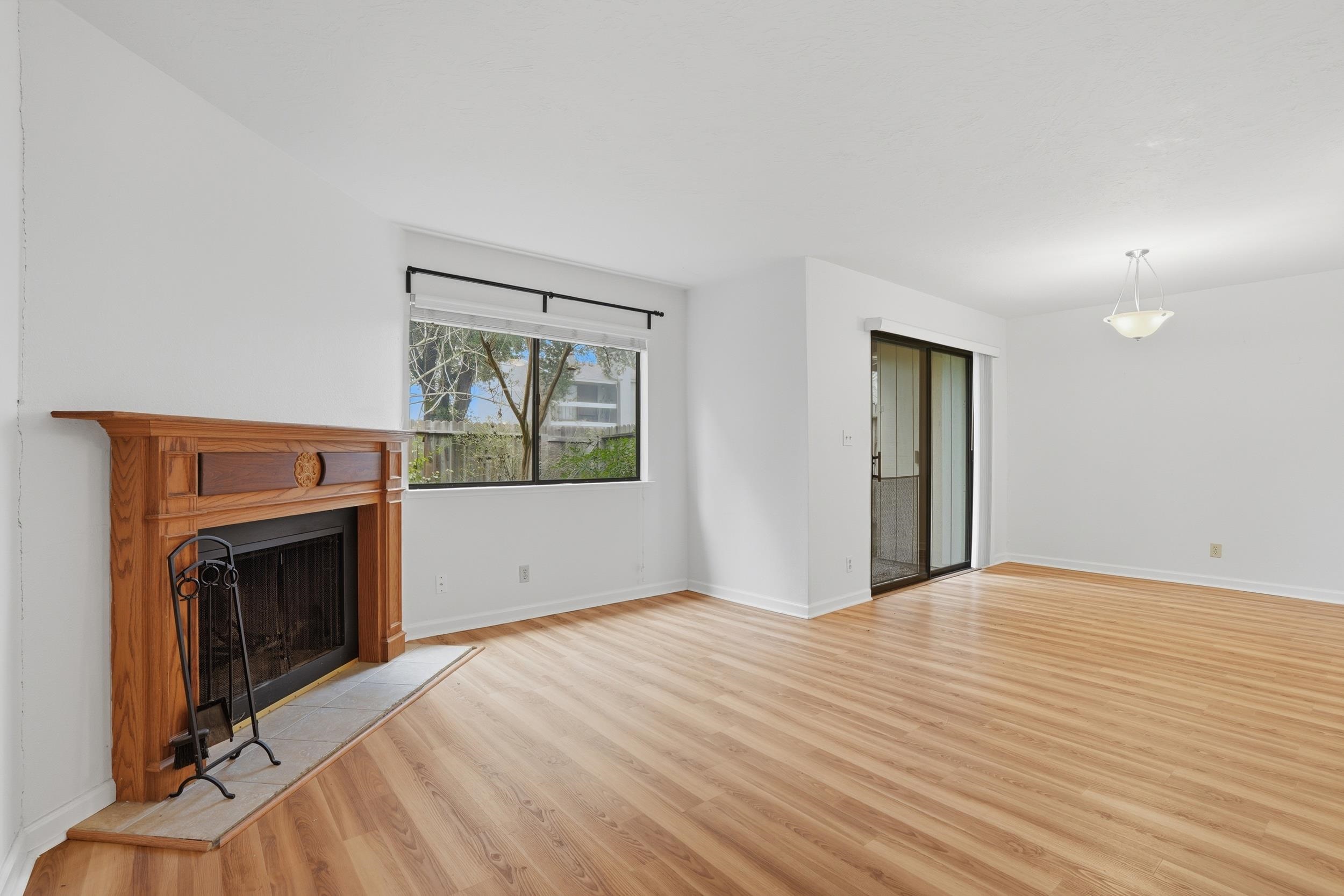3401 Bermuda Avenue, Unit 6 Davis, CA 95616 - Photo 19 of 43 a view of empty room with a fireplace and wooden floor