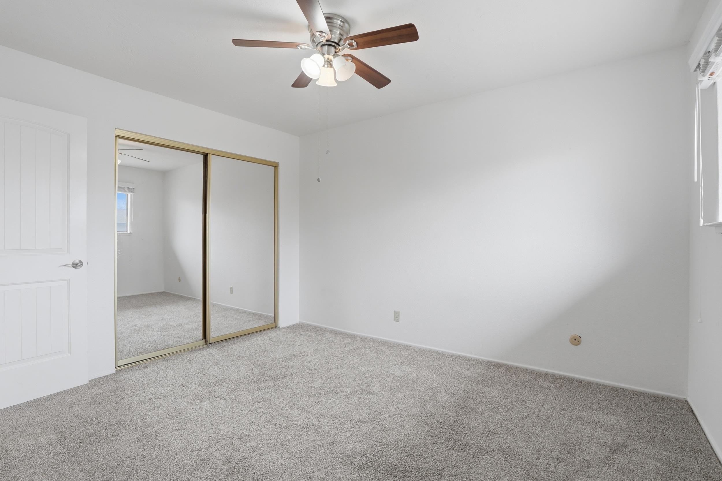 3401 Bermuda Avenue, Unit 6 Davis, CA 95616 - Photo 28 of 43 an empty room with a ceiling fan and a window