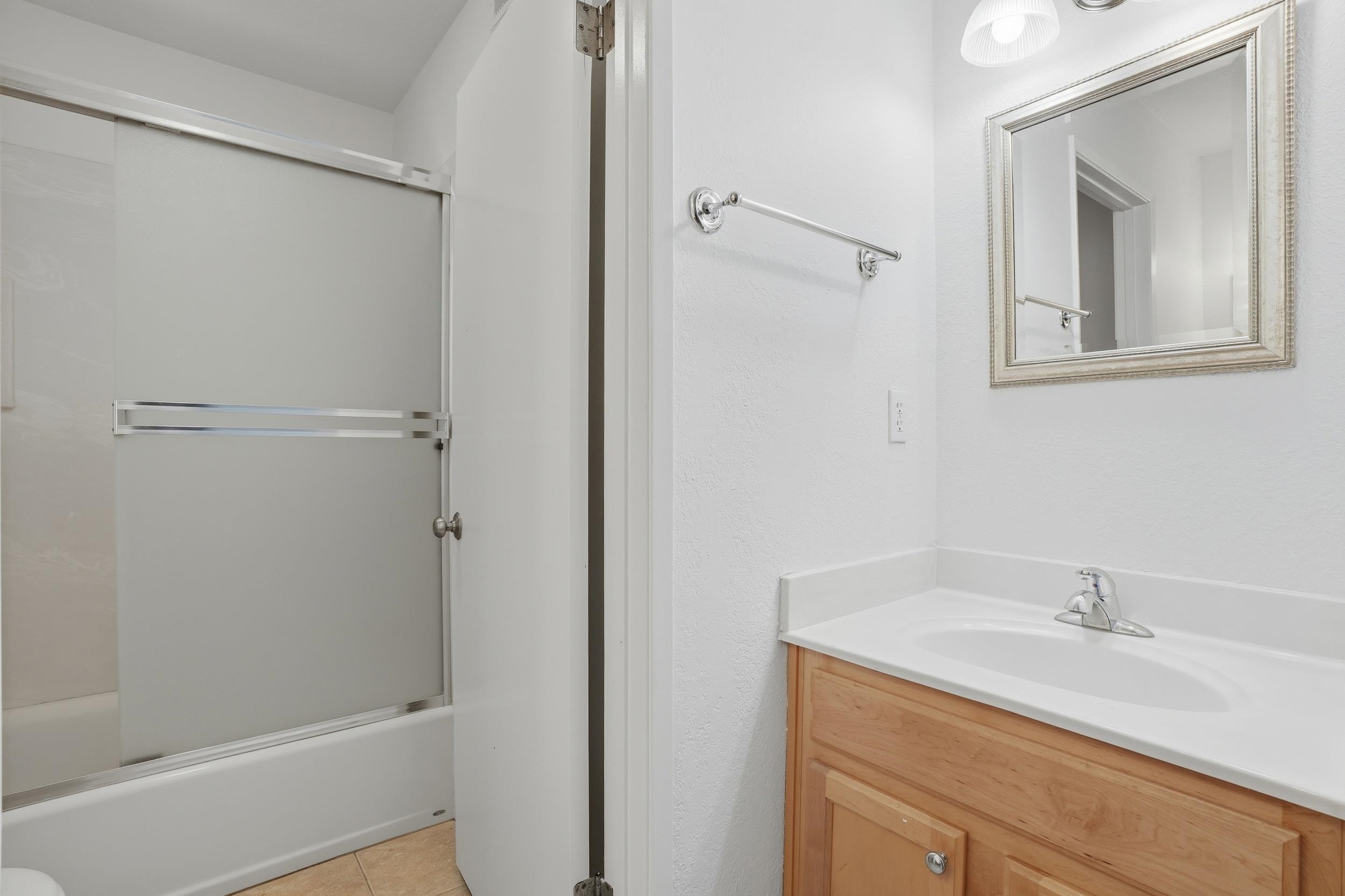 3401 Bermuda Avenue, Unit 6 Davis, CA 95616 - Photo 31 of 43 a bathroom with a granite countertop sink toilet and shower
