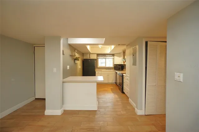 a view of a hallway with a kitchen