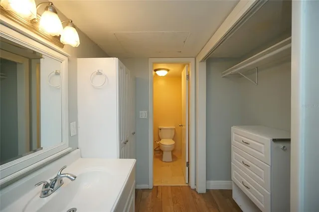 a bathroom with a tub sink and mirror