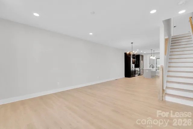 an empty room with a window and a ceiling fan