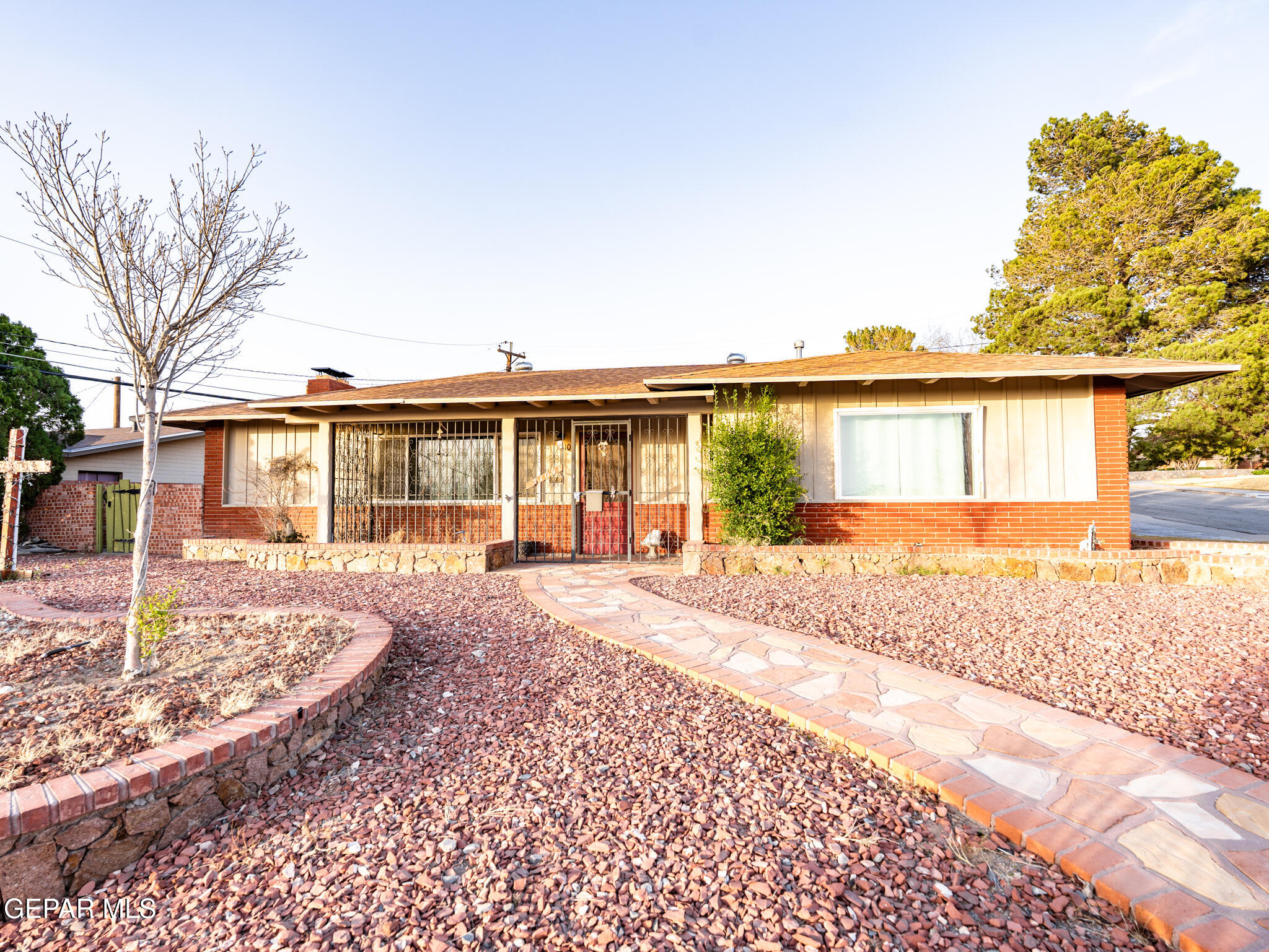 a front view of a house with a garden and patio