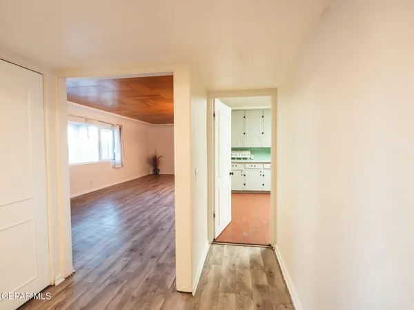 a view of empty room with wooden floor