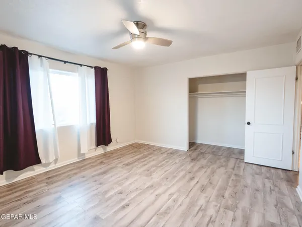 a view of a room with wooden floor and windows