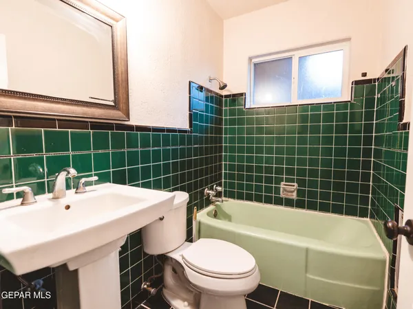 a utility room with wooden floor washer and dryer