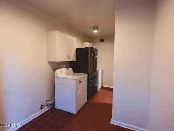 a view of room with refrigerator and washer
