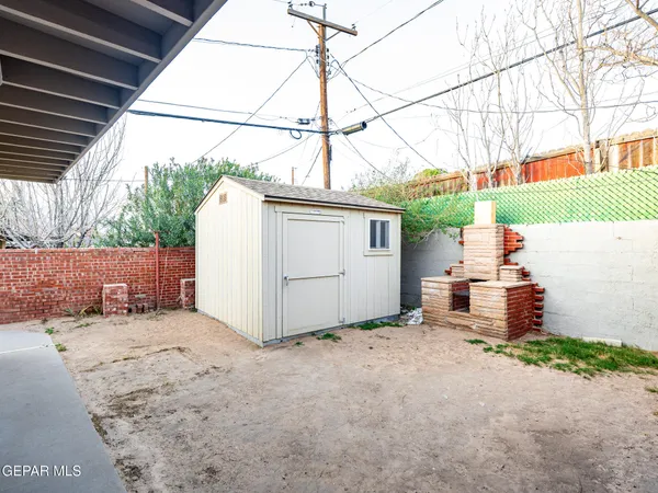a view of a house with wooden fence