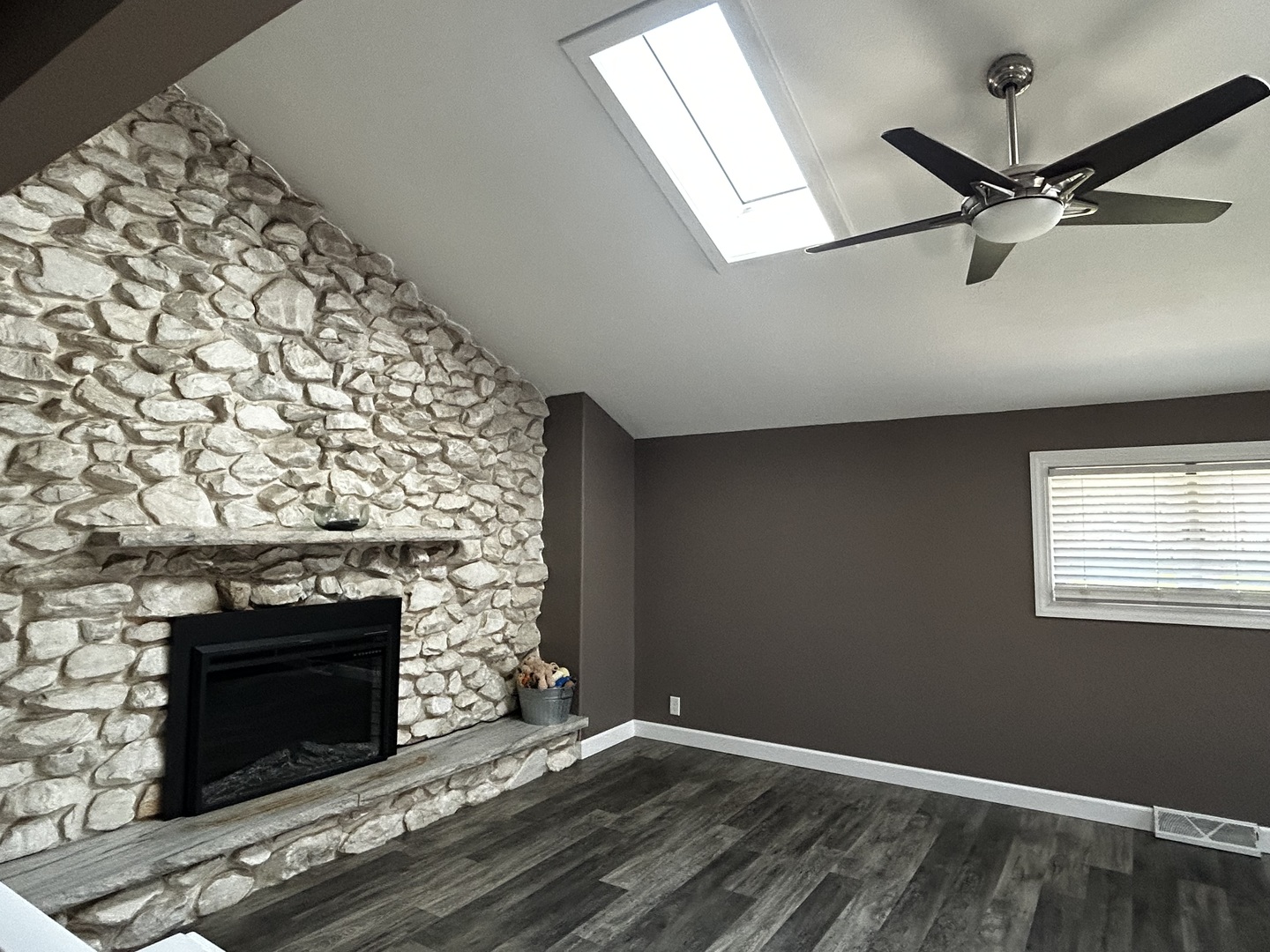 12795 Lawrence Road Sterling, IL 61081 - Photo 15 of 42 an empty room with a fireplace and wooden floor