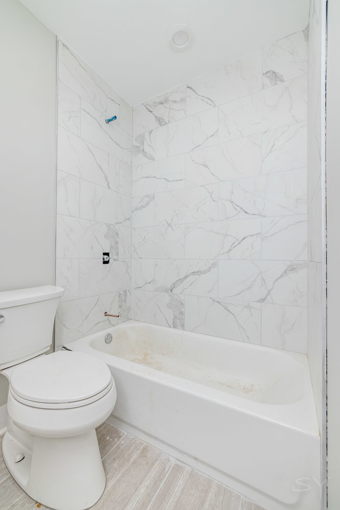 2450 South Oakley Avenue, Unit 2R Chicago, IL 60608 - Photo 7 of 9 a bathroom with a toilet and a bath tub