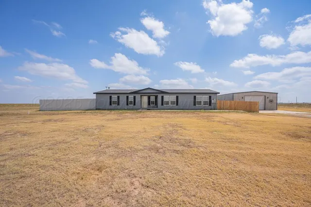a view of a house with a big yard