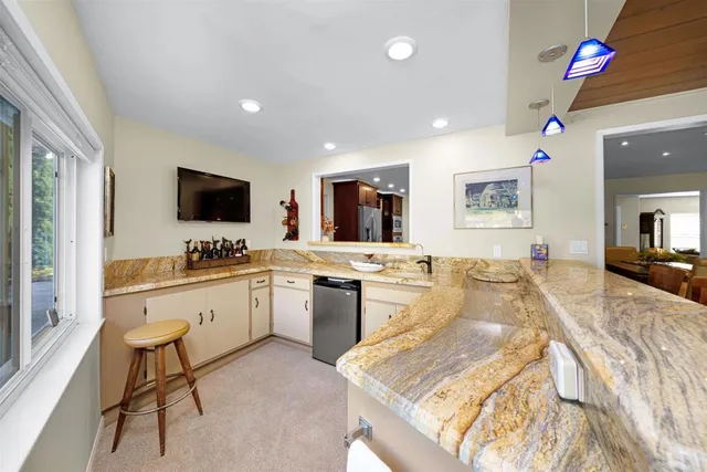 a large white kitchen with a large window
