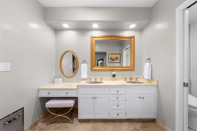 a bathroom with a toilet a sink and a mirror