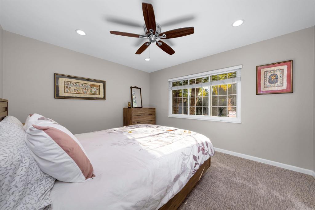 4711 Lorena Place El Cajon, CA 92020 - Photo 16 of 33 a bedroom with a bed and a large window