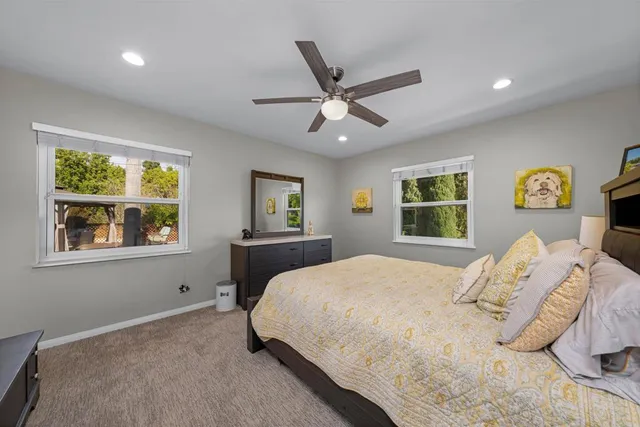 a bedroom with a large bed and a window