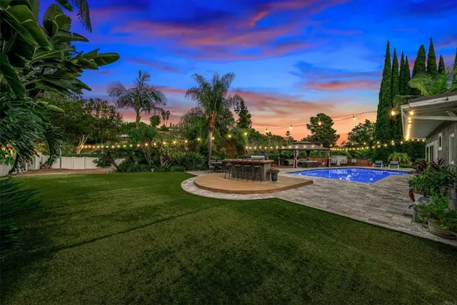 a view of a fountain in front of house with a yard