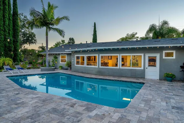 a front view of house with yard and outdoor seating