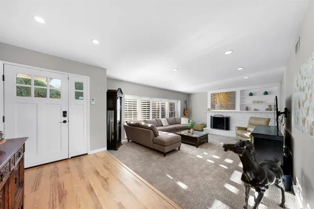 a living room with furniture flat screen tv and a window