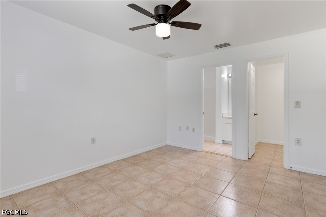 221 Meadow Road Lehigh Acres, FL 33973 - Photo 13 of 13 an empty room with closet and a chandelier fan