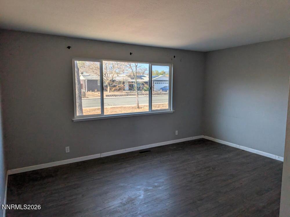 848 C Street Fernley, NV 89408 - Photo 7 of 15 an empty room with wooden floor and windows