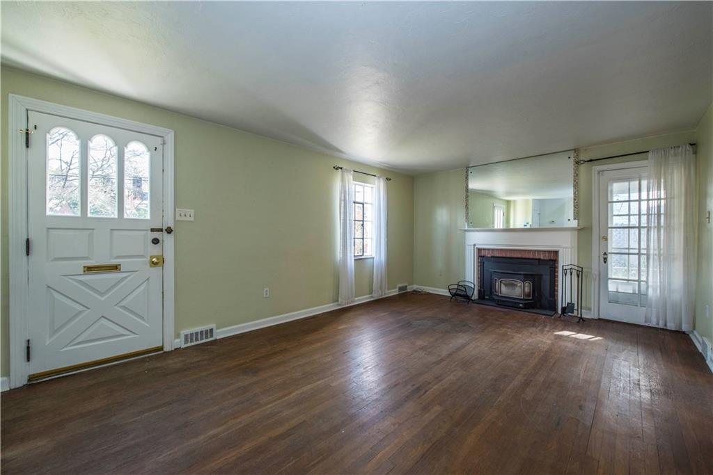 2347 Collins Road Pittsburgh, PA 15235 - Photo 2 of 25 Spacious living room with wood burning stove and access to outdoor side porch.