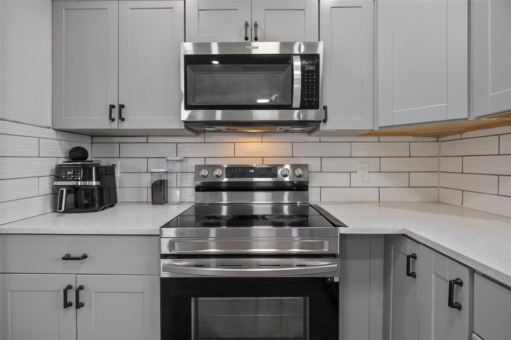 114 Inwood Circle Brandon, FL 33510 - Photo 9 of 31 a kitchen with stainless steel appliances granite countertop a stove and a microwave