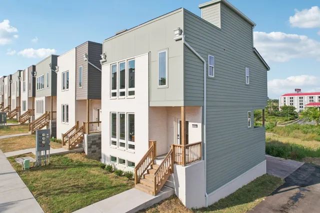a front view of a house with a garden
