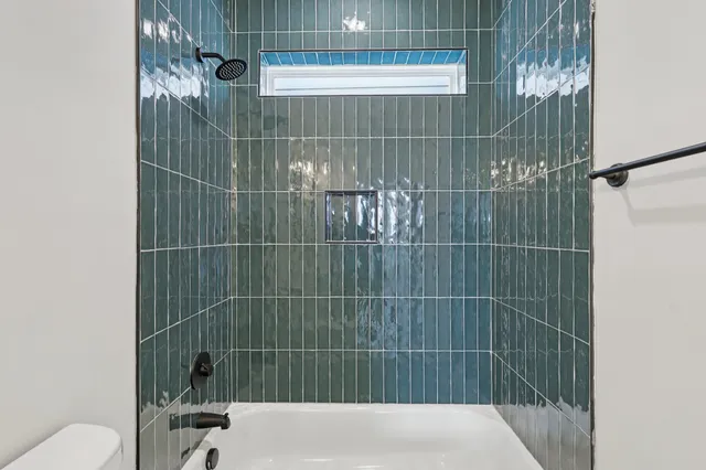 a bathroom with a shower and a toilet