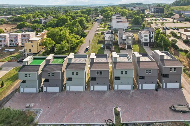 an aerial view of residential houses with outdoor space
