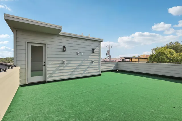 a view of a backyard with potted plants and wooden fence