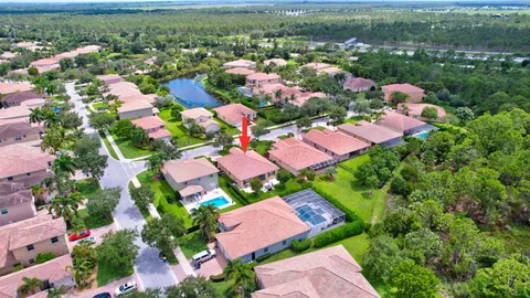 an aerial view of residential houses with outdoor space and swimming pool
