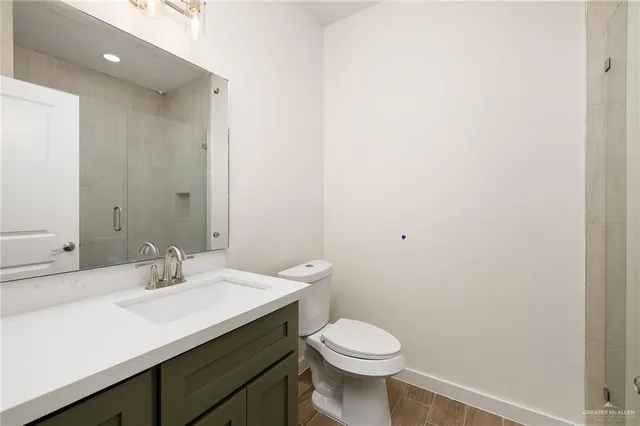 a bathroom with a sink a toilet and mirror