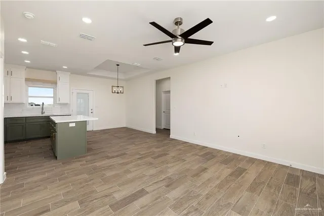a view of a kitchen with a sink and stainless steel appliances