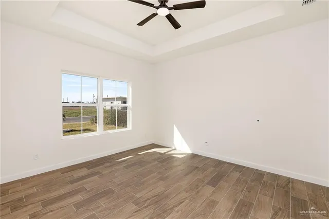 a view of a livingroom with a ceiling fan and window
