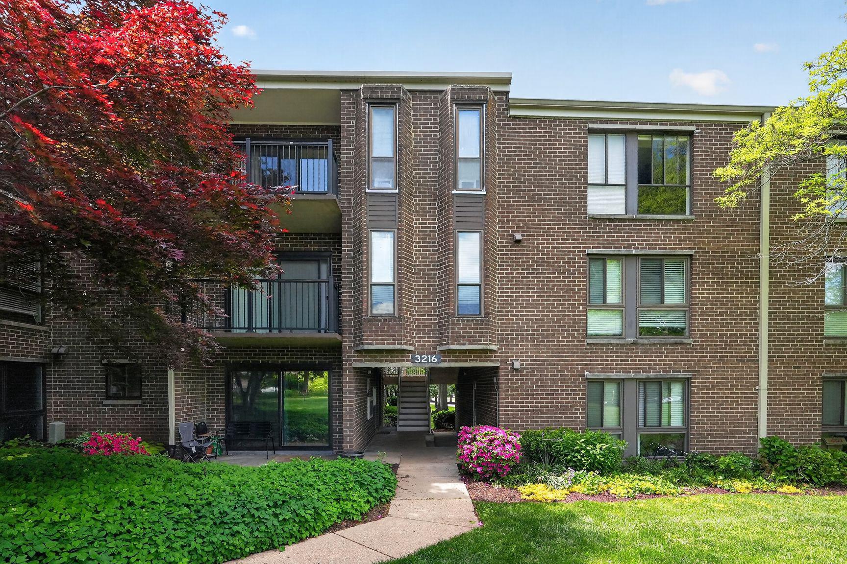 Charming brick building with lush gardens