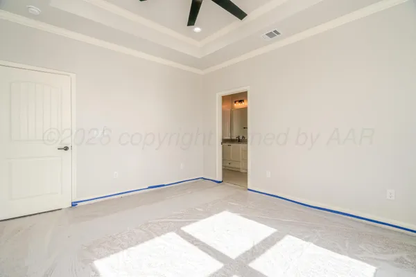 an empty room with a ceiling fan and carpet