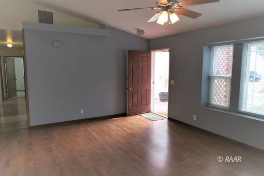 412 Veada Avenue Ridgecrest, CA 93555 - Photo 5 of 35 an empty room with wooden floor and windows