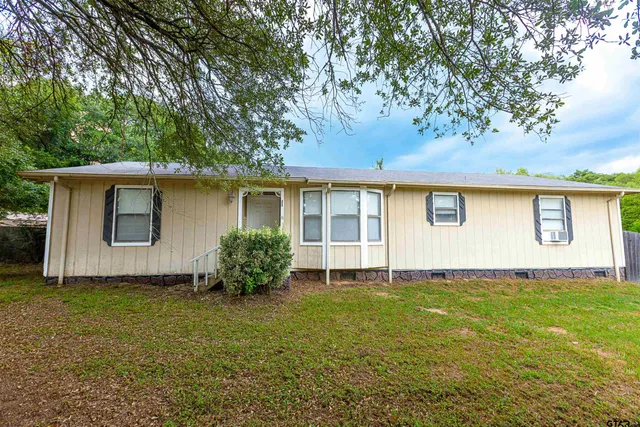 a house with trees in the background
