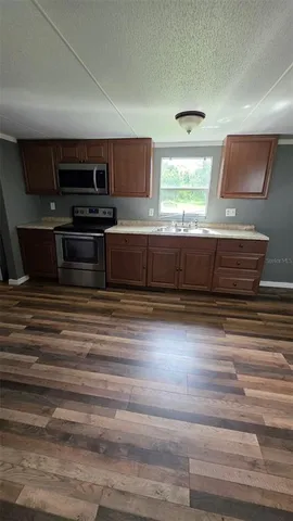 a kitchen with wooden cabinets and stainless steel appliances