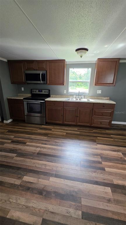 3525 Reynolds Road Bartow, FL 33830 - Photo 5 of 13 a kitchen with wooden cabinets and stainless steel appliances