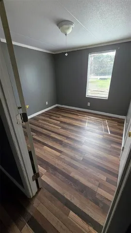 a view of a room with wooden floor and staircase
