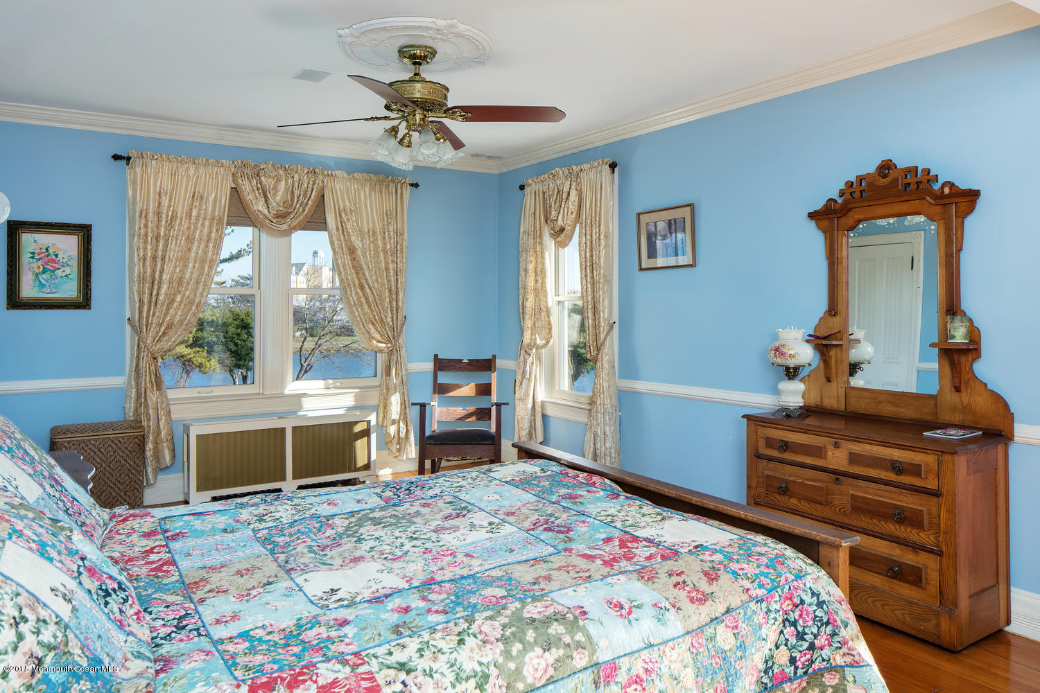 203 East Lake Avenue Spring Lake, NJ 07762 - Photo 30 of 55 a bedroom with a bed and a chandelier
