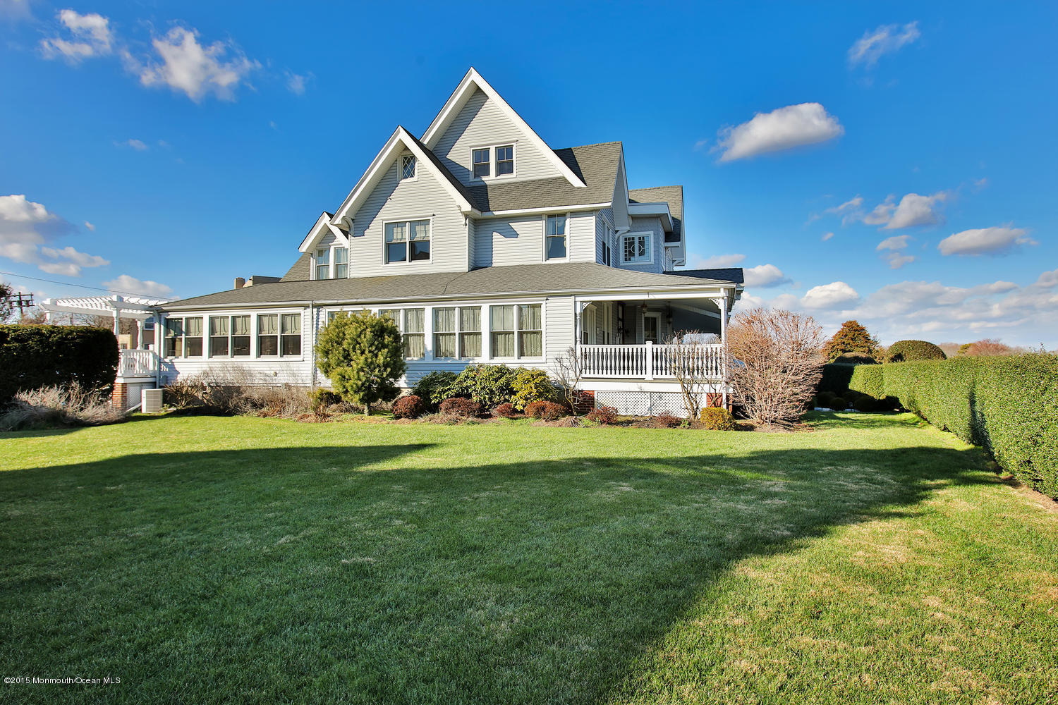 203 East Lake Avenue Spring Lake, NJ 07762 - Photo 44 of 55 a front view of a house with a garden and plants