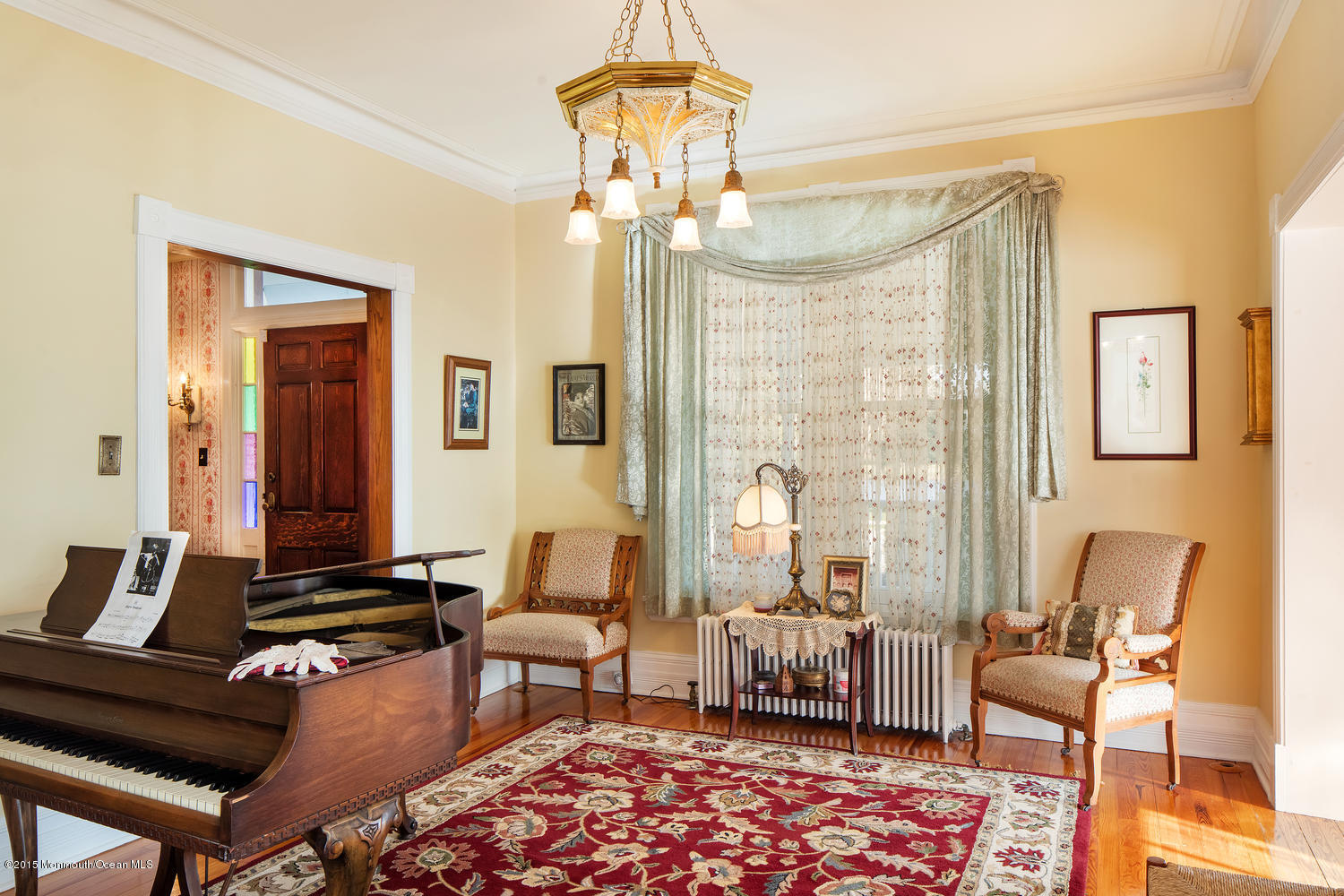 203 East Lake Avenue Spring Lake, NJ 07762 - Photo 8 of 55 a living room with furniture and a chandelier